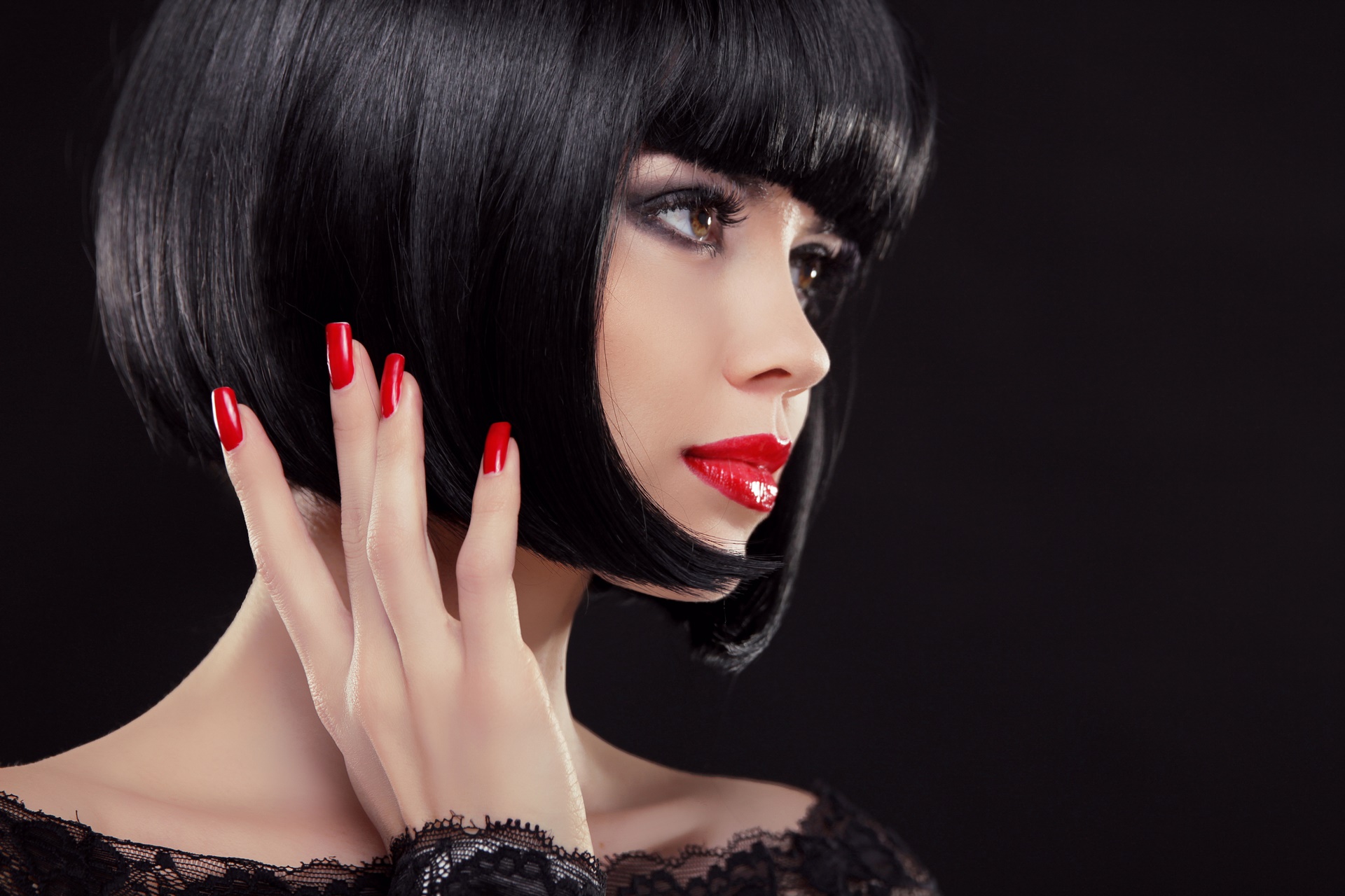 Bob short black hairstyle. Manicured nails and red lips. Fashion